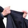 Hands holding a black motorcycle cover with anti-theft locks.