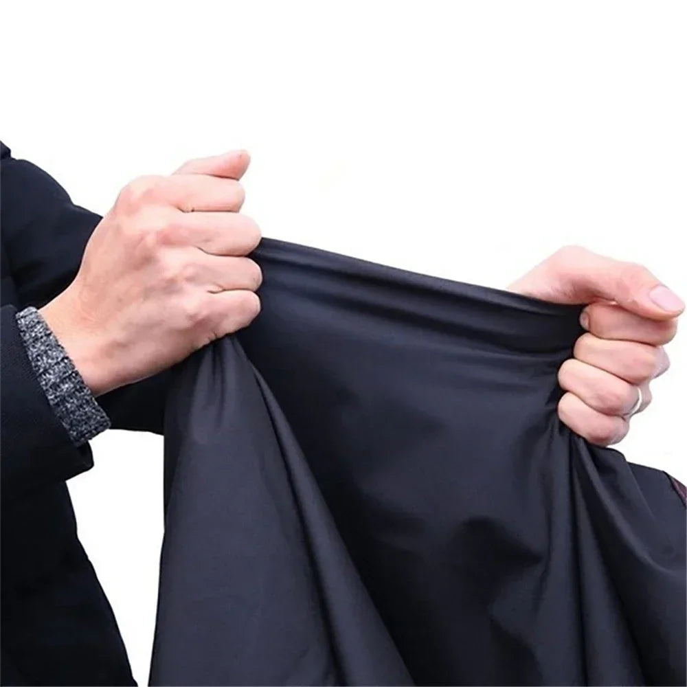 Hands holding a black motorcycle cover with anti-theft locks.
