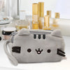 A gray cat plush pencil case with a zipper closure resting on a white surface.