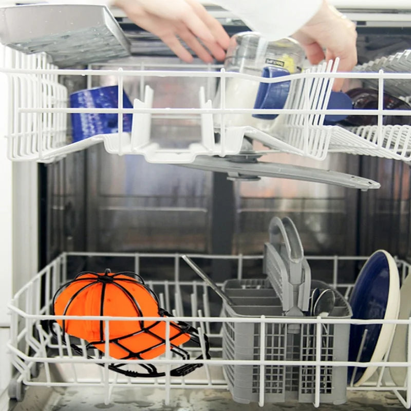 A white plastic hat washing cage set for baseball caps is being loaded into a dishwasher.