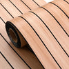 Roll of light wood veneer panel with black lines, showing the texture and layered construction.