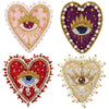 Two heart-shaped patches featuring sparkling beads and rhinestones, one pink and gold, the other purple and gold.