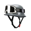 A gray lightweight half helmet with integrated goggles is shown for motorcycle and scooter riders.