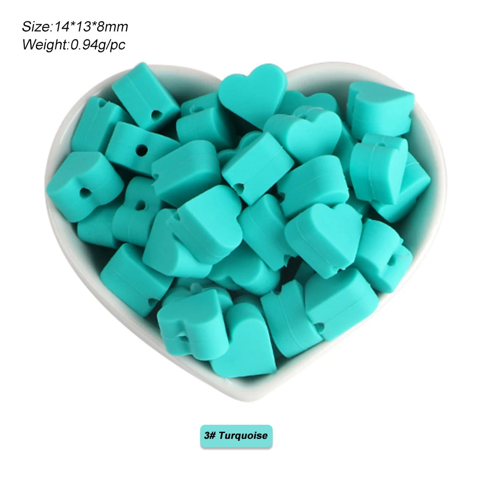 A pile of turquoise silicone crown star heart beads for DIY jewelry making
