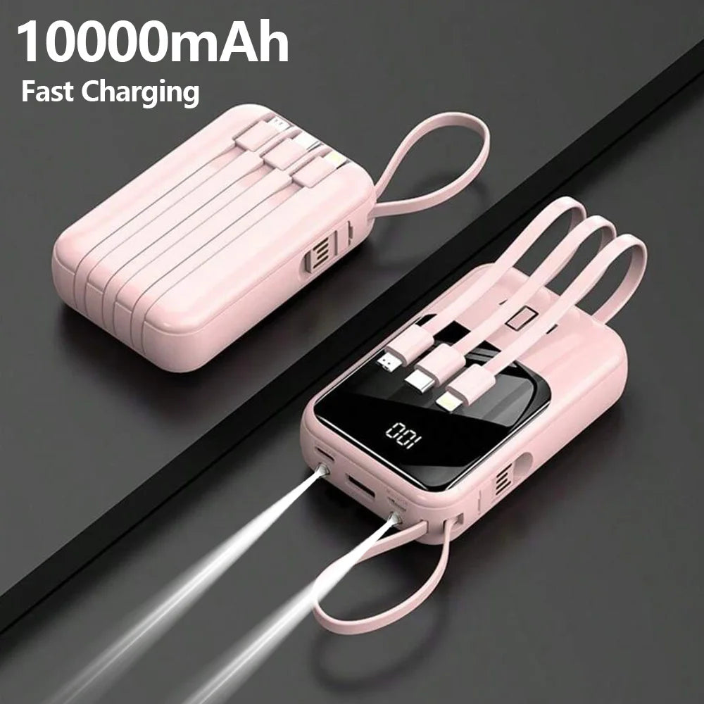 A pink 10000mAh portable power bank with built-in cables and a flashlight is shown lying on a dark surface.