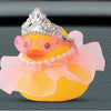 Three yellow rubber duck decorations adorned with princess crowns, sunglasses, and pearl necklaces.