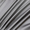 A close-up of a draped, silky gray bamboo flat sheet fabric.