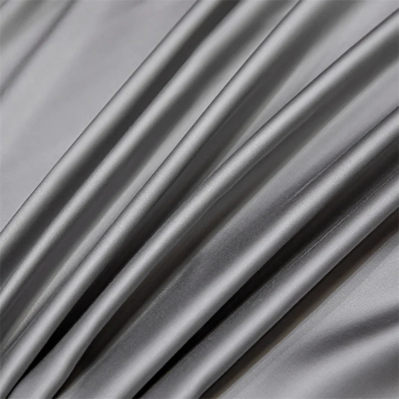 A close-up of a draped, silky gray bamboo flat sheet fabric.