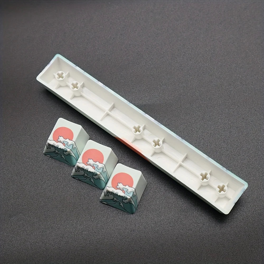 A white plastic tray holding several pink and white coral sea themed PBT keycaps for mechanical keyboards.
