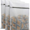Set of three reusable mesh laundry bags filled with delicate items