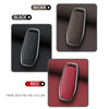 Three car key cases in brown, black, and red colors shown with a close-up view.