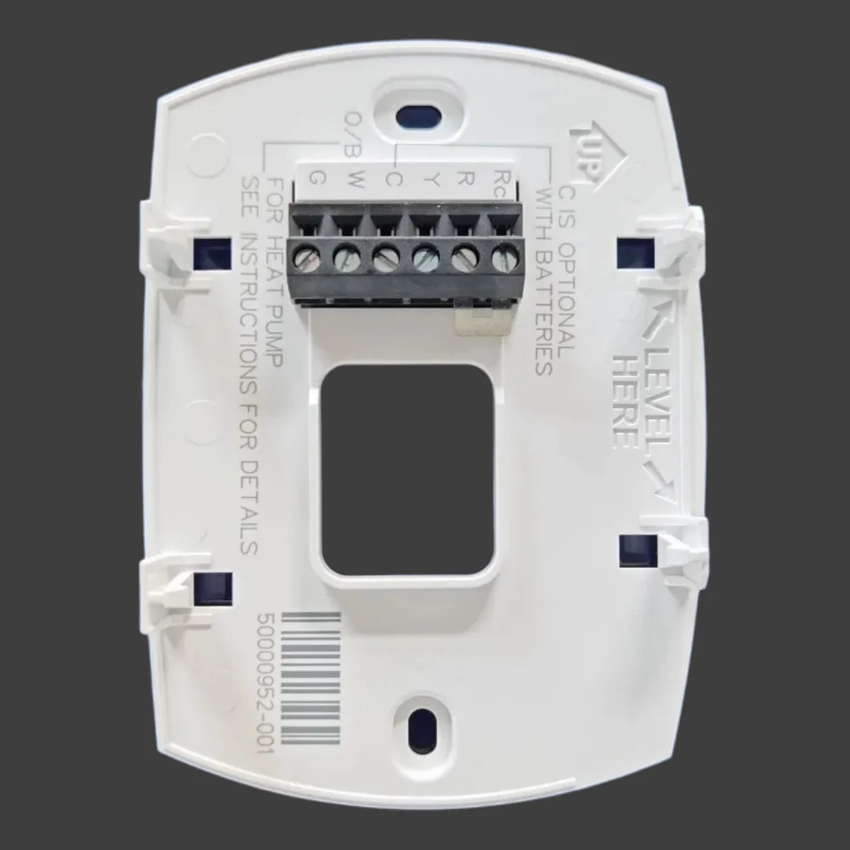 White digital non-programmable thermostat with a large LCD display and various connection points