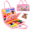 A pink Montessori busy board for toddlers featuring various sensory learning toys and accessories.