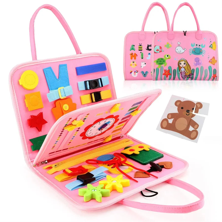 A pink Montessori busy board for toddlers featuring various sensory learning toys and accessories.