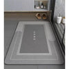 A gray bath mat with a non-slip rubber base is displayed on a shelf next to some toiletries and sandals.