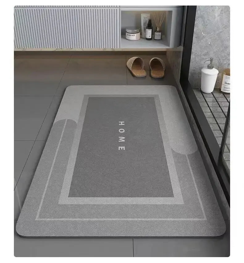 A gray bath mat with a non-slip rubber base is displayed on a shelf next to some toiletries and sandals.