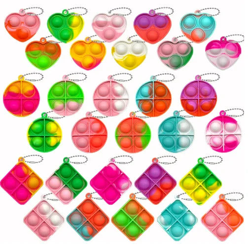 A collection of colorful mini pop keychain fidget toys in various shapes and colors.