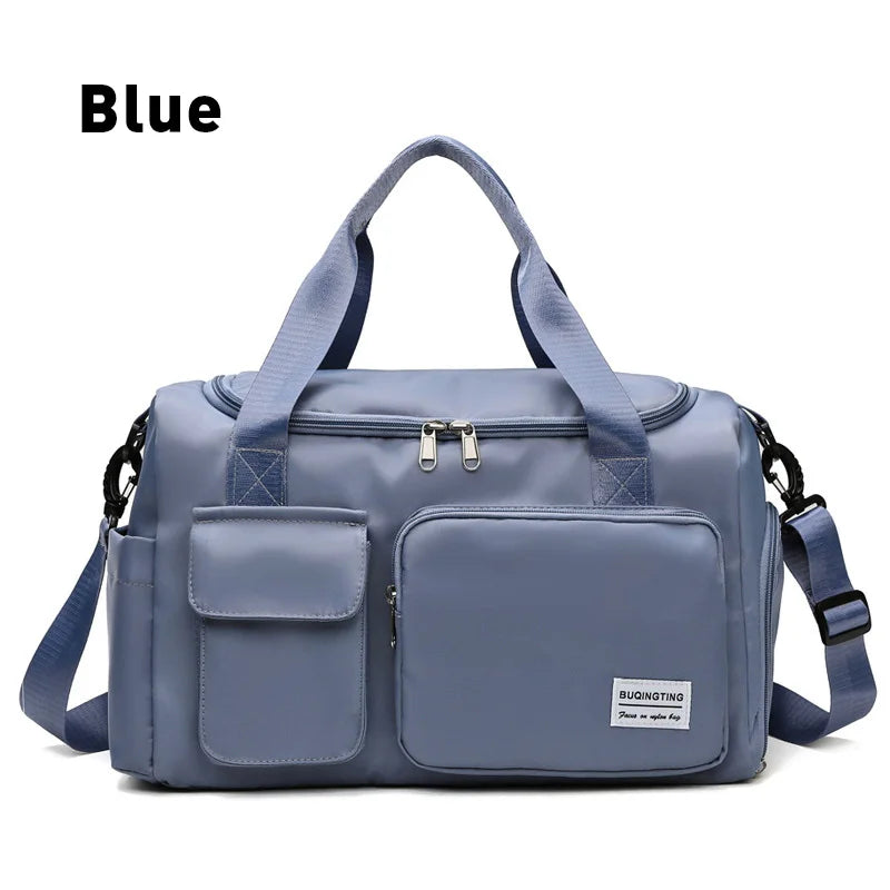 A blue waterproof travel duffle bag with a shoe compartment and shoulder straps.