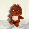 A brown and pink plush toy resembling a fox or squirrel character.