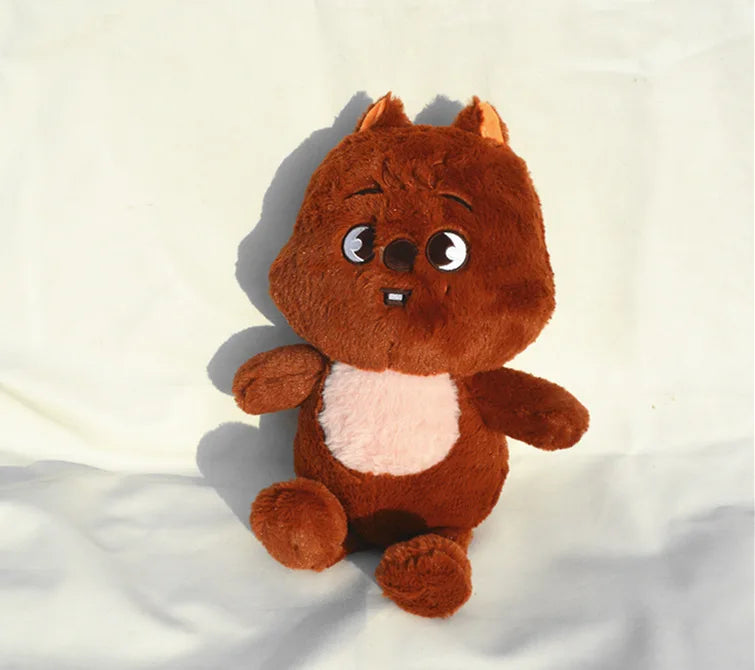 A brown and pink plush toy resembling a fox or squirrel character.