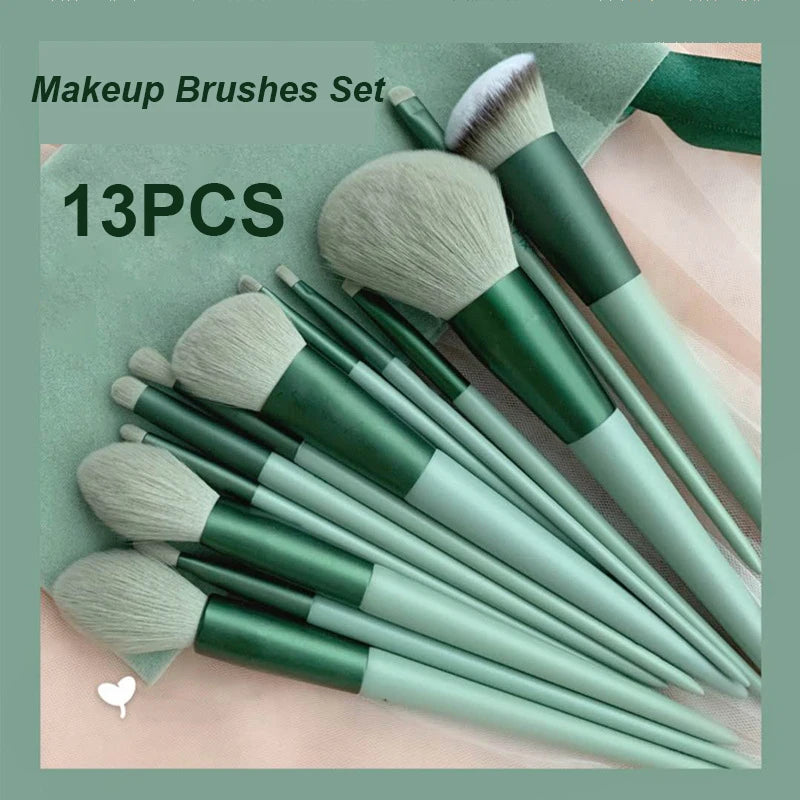 A set of thirteen makeup brushes in various shades of green and beige displayed on a light surface.