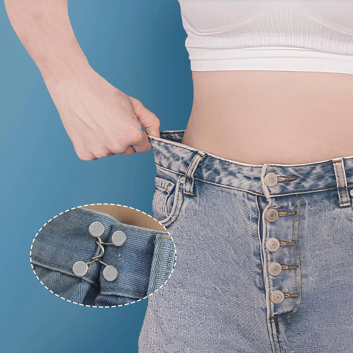 Close-up of denim jeans showing a button extender detail on the waistband.