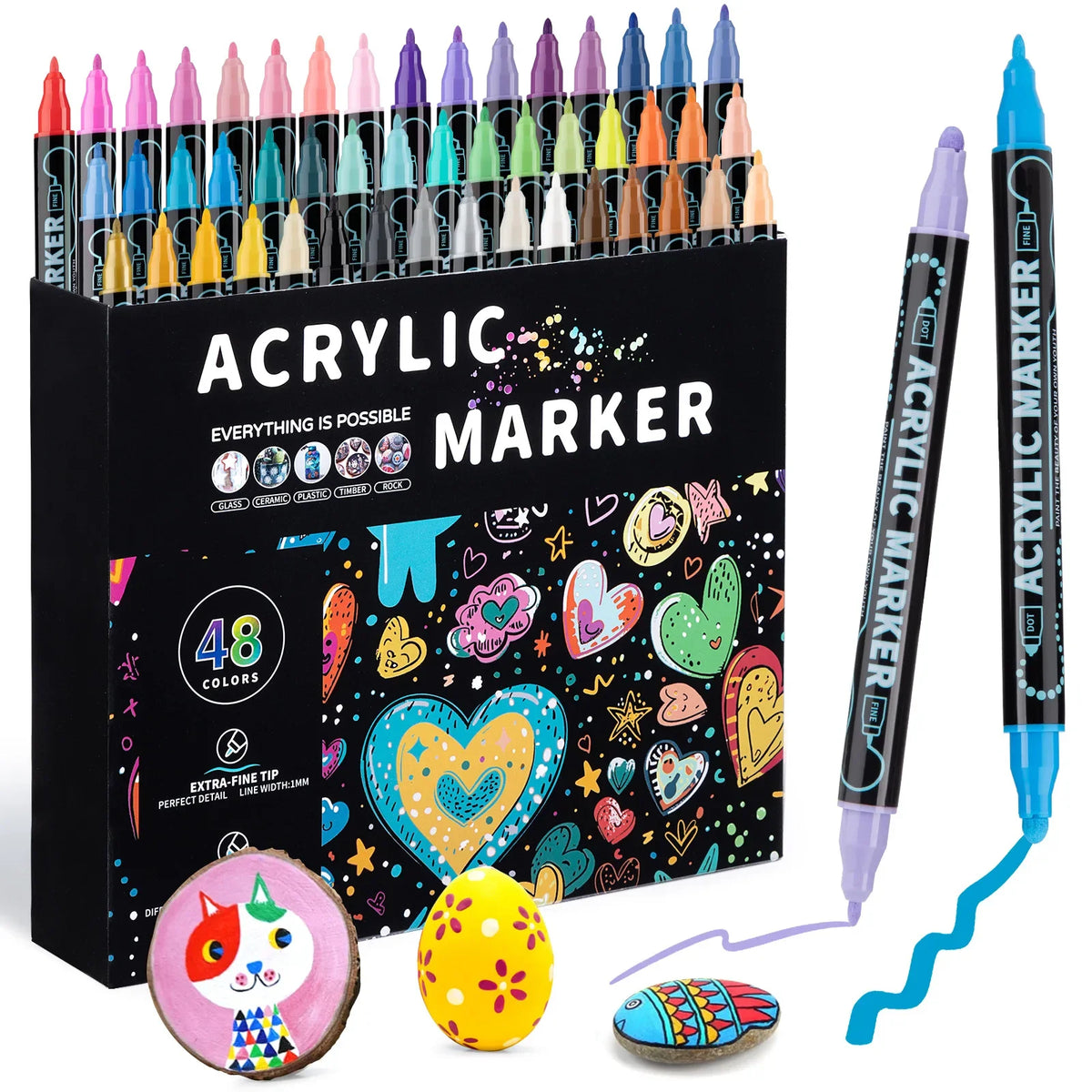 A set of acrylic marker pens in various colors and tips displayed in a black box with craft items.