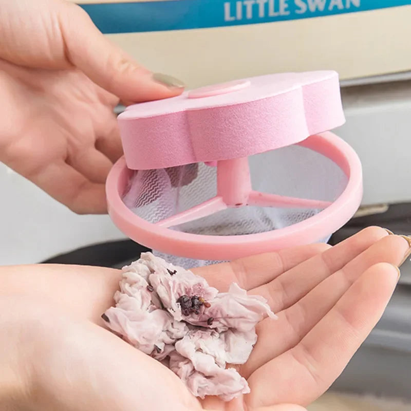 Pink filter bags for washing machine lint and hair catcher, held in a hand.