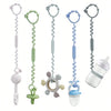 A set of adjustable silicone pacifier chains in various colors, including white, green, blue, and gray, shown next to a clear