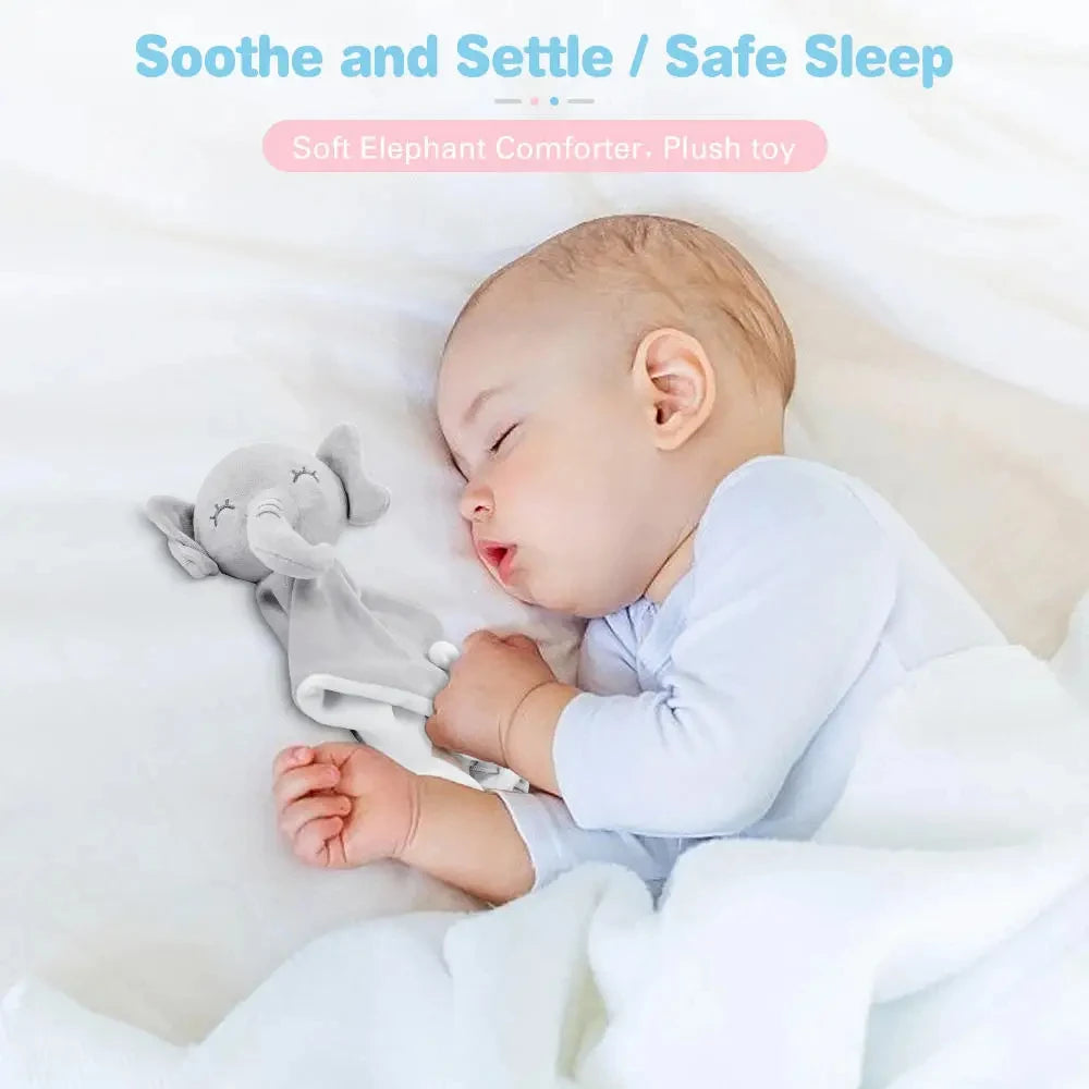 A baby is sleeping peacefully with a soft gray elephant plush toy and white blanket.