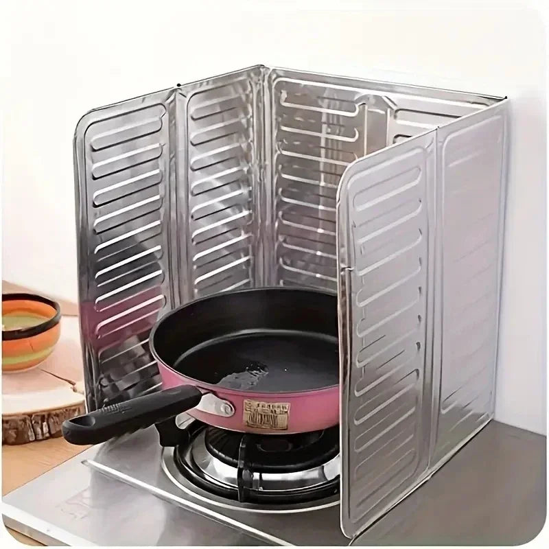 Foldable aluminum stove splatter guard with a pink pot placed on a stovetop.