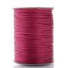A spool of magenta waxed cotton cord used for jewelry making