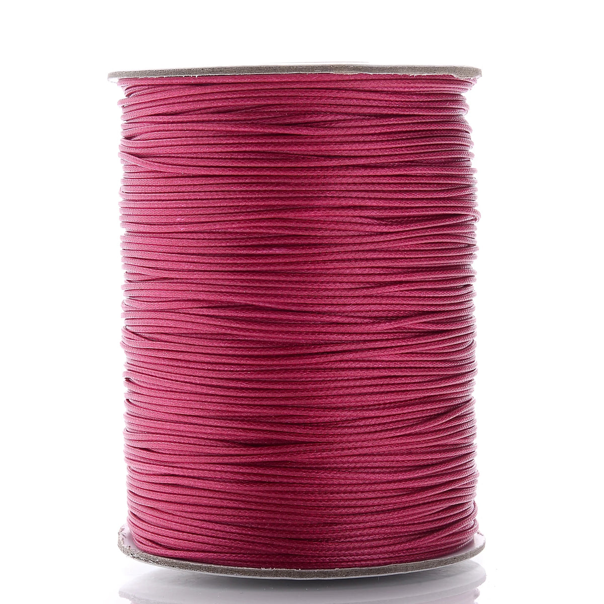 A spool of magenta waxed cotton cord used for jewelry making