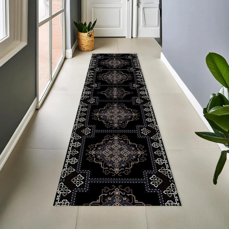 A long runner rug with a black and white geometric tribal pattern placed on a light tiled floor.