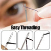Close-up of a stainless steel self-threading sewing needle being used for hand sewing.