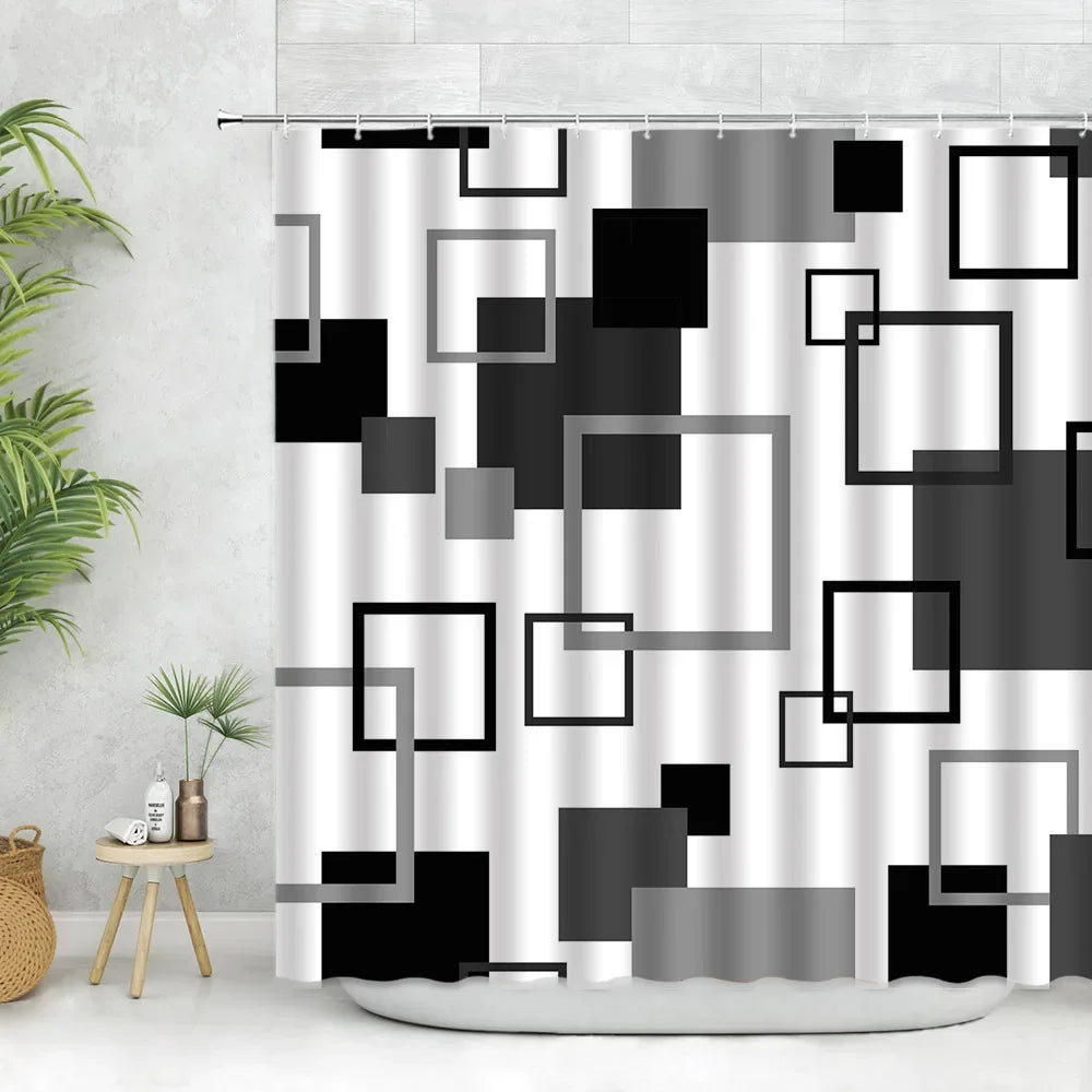 Geometric black and white fabric shower curtain featuring various square shapes with hooks