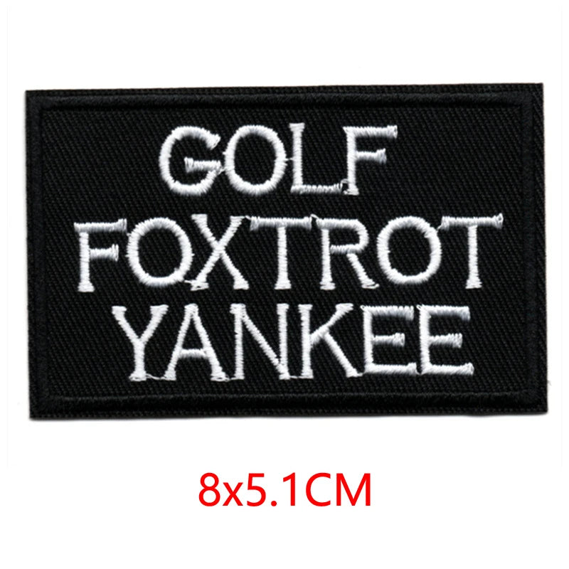 Black embroidered iron-on letter patch with white text reading GOLF FOXTROT YANKEE