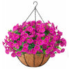 A vibrant arrangement of pink and magenta artificial morning glory flowers hanging from a black wire, displayed in a woven ba