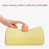 A hand is placing an egg onto a yellow memory foam pillow for demonstration.