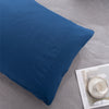 A deep blue microfiber pillowcase is shown on a light gray fabric surface.
