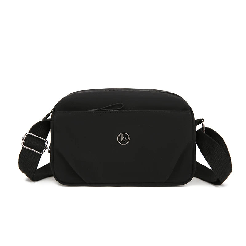 Black lightweight water-resistant nylon crossbody bag with a flap and adjustable strap.