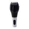 A close-up view of a leather-wrapped gear shift knob with a silver base and black top.