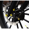 Close-up of a motorcycle wheel with decorative screw cap covers and bolts.