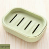 A light green compact travel soap holder with a secure lid, featuring three slots for holding bars of soap.