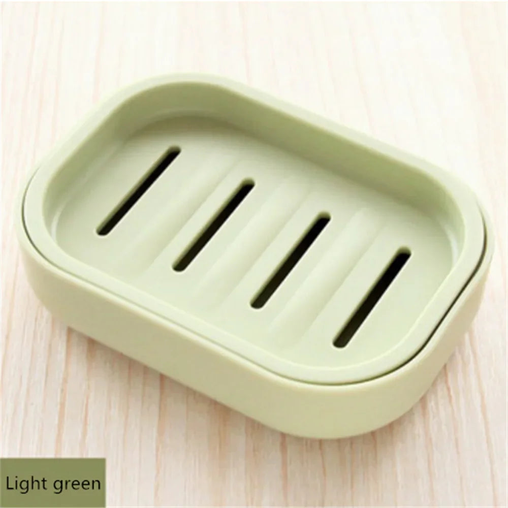 A light green compact travel soap holder with a secure lid, featuring three slots for holding bars of soap.