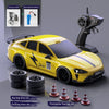 Yellow RC drift truck with racing and drifting tires and a charging cable