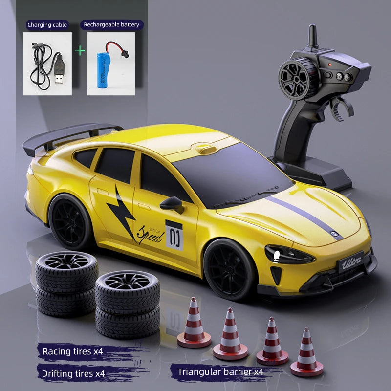 Yellow RC drift truck with racing and drifting tires and a charging cable