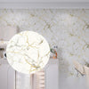 Marble pattern peel and stick self-adhesive wallpaper covering a kitchen wall with white and gold veining