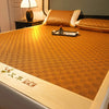 A close-up of a textured orange cooling mat with a decorative pattern, resting on a bed or surface.