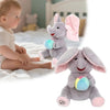 A gray elephant plush toy with pink ears and a colorful ball, sitting next to a baby.